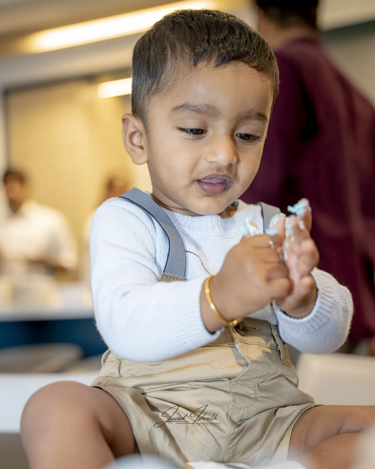A toddler holding a piece of birthday decoration